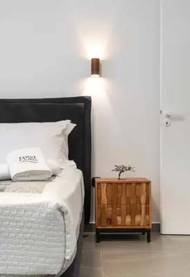 a bedroom with a bed and a table with a lamp at Glyfada Gallery Apartment by First Class Properties in Athens