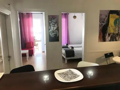 a living room with a table and a room with a bedroom at Athens by foot: Perfect flat with terrace in Athens