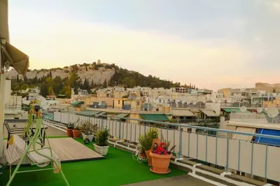 a balcony with a view of a city at Rooftop studio, Acropolis view! in Athens