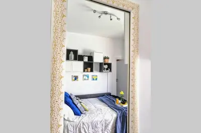a large mirror in a bedroom with a bed at Rooftop studio, Acropolis view! in Athens