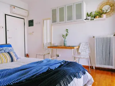 a bedroom with a bed and a table and chairs at Rooftop studio, Acropolis view! in Athens