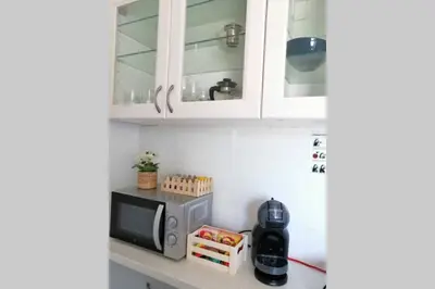 a kitchen with white cabinets and a microwave at Rooftop studio, Acropolis view! in Athens