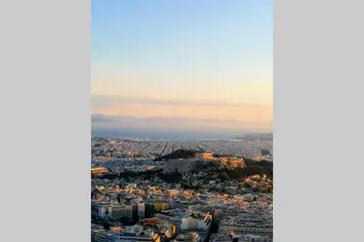 an aerial view of a city at dusk at Rooftop studio, Acropolis view! in Athens