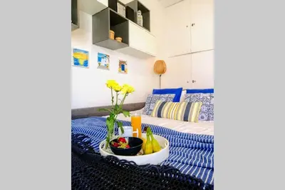 a room with a bed and a bowl of fruit at Rooftop studio, Acropolis view! in Athens