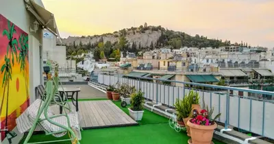 a balcony with a view of a city at Rooftop studio, Acropolis view! in Athens