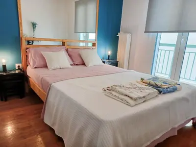 a bedroom with a bed with two towels on it at Green tea balcony - quiet & cozy- Ano Glyfada in Athens