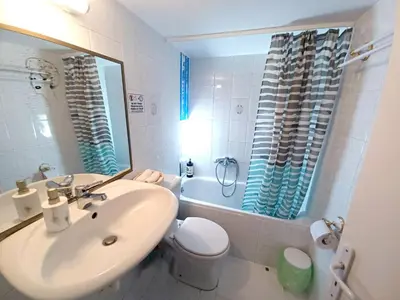 a bathroom with a sink and a toilet and a mirror at Green tea balcony - quiet & cozy- Ano Glyfada in Athens