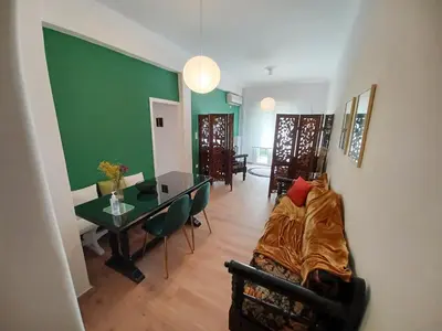 a living room with a couch and a table at Green tea balcony - quiet & cozy- Ano Glyfada in Athens