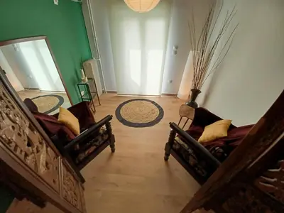 a living room with two chairs and a mirror at Green tea balcony - quiet & cozy- Ano Glyfada in Athens