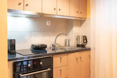a small kitchen with a sink and a stove at Acropolis Sweet House 3 in Athens