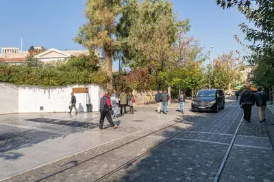 a group of people walking down a street at Acropolis Sweet House 3 in Athens