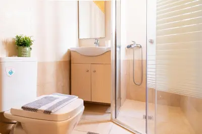 a bathroom with a toilet and a sink and a shower at Acropolis Sweet House 3 in Athens