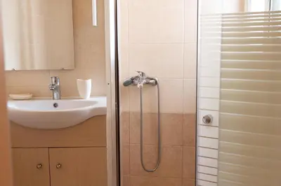 a bathroom with a shower and a sink at Acropolis Sweet House 3 in Athens