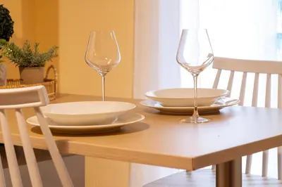 two wine glasses sitting on top of a wooden table at Acropolis Sweet House 3 in Athens