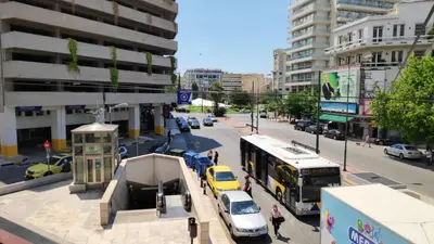 a busy city street with cars and a bus at Omega54 City Suites Athens Central Business District in Athens