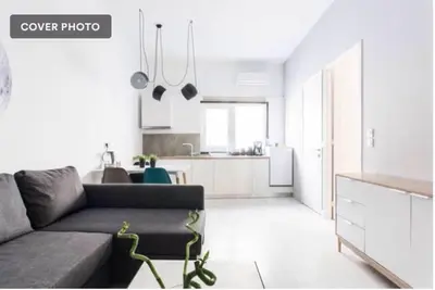 a living room with a couch and a kitchen at Dion Suites in Athens