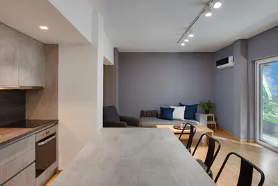 a kitchen and living room with a table and chairs at Athenian Stylish Living in Athens