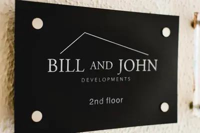 a sign on a wall that reads bill and joindevelopments and floor at Athenian Stylish Living in Athens