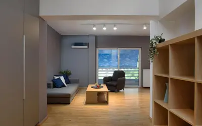 a living room with a couch and a chair and a table at Athenian Stylish Living in Athens