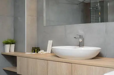 a bathroom with a white sink on a counter at Athenian Stylish Living in Athens