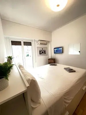 a bedroom with a large white bed in a room at Olympic Hadrian Apartment next to Acropolis in Athens