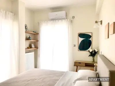 a bedroom with a bed and a window at Sunkissed Terrace Apartments in Athens