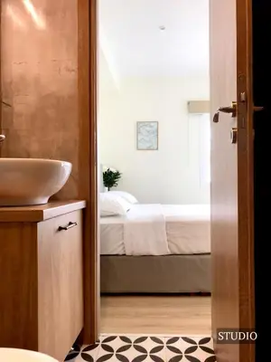 a bathroom with a sink and a bed at Sunkissed Terrace Apartments in Athens