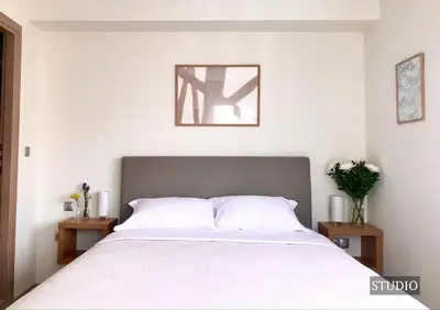 a bedroom with a large white bed with two tables at Sunkissed Terrace Apartments in Athens