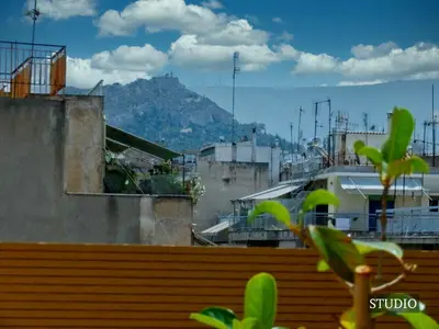 a view of a city with a mountain in the background at Sunkissed Terrace Apartments in Athens