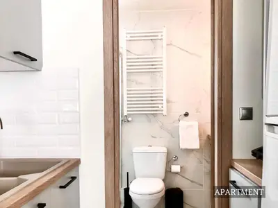 a bathroom with a toilet and a sink at Sunkissed Terrace Apartments in Athens