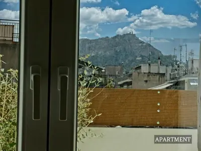 a view of a mountain from a window at Sunkissed Terrace Apartments in Athens