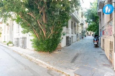 a motorcycle parked on the side of a street at Pan's Cave Studio in Plaka in Athens