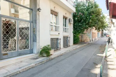 an empty street in front of a building at Pan's Cave Studio in Plaka in Athens