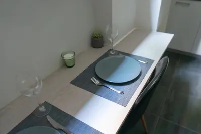 a table with a plate and two wine glasses at Pan's Cave Studio in Plaka in Athens