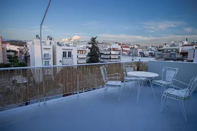 a table and chairs on a balcony with a view at Luxury Apt 115m2 in Athens