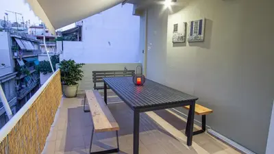 a table and two benches in a room with a table at Luxury Apt 115m2 in Athens