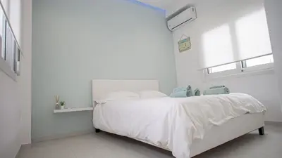 a white bedroom with a white bed and windows at Luxury Apt 115m2 in Athens