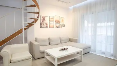 a living room with a couch and a table at Luxury Apt 115m2 in Athens