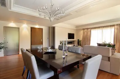 a dining room and living room with a table and chairs at Villa Sabia in Vari