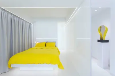 a bedroom with a yellow bed with a yellow blanket at White Penthouse in Athens
