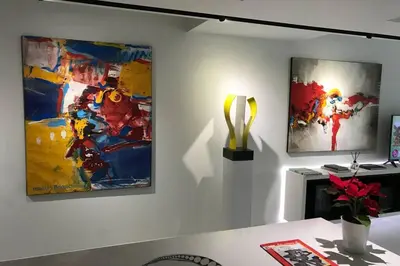 a room with two paintings and a trophy on a wall at White Penthouse in Athens