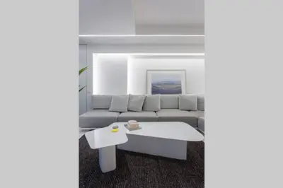 a living room with a couch and a coffee table at White Penthouse in Athens