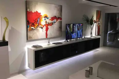 a living room with a large painting on the wall at White Penthouse in Athens