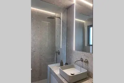 a bathroom with a sink and a shower at Gray Studio in Athens