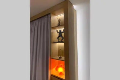 a room with a window with a shelf with a cross at Gray Studio in Athens