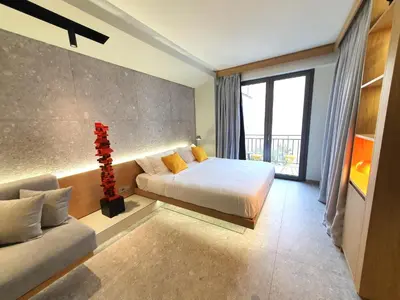 a hotel room with a bed and a couch at Gray Studio in Athens