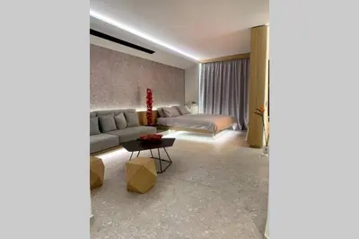 a living room with a couch and a bed at Gray Studio in Athens