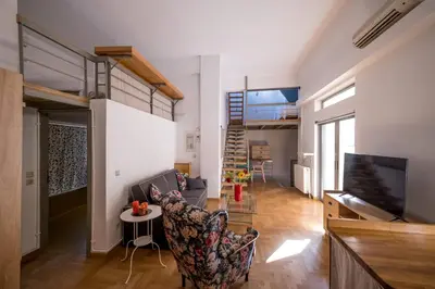 a living room with a loft bed and a couch at THISIO LOFT in Athens