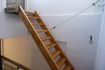 a ladder hanging from a ceiling in a room at THISIO LOFT in Athens