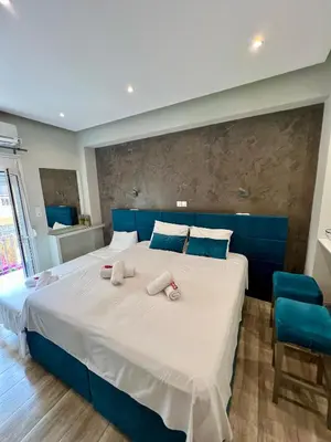 a bedroom with a large bed with towels on it at Emerald Lux Apartment in Athens